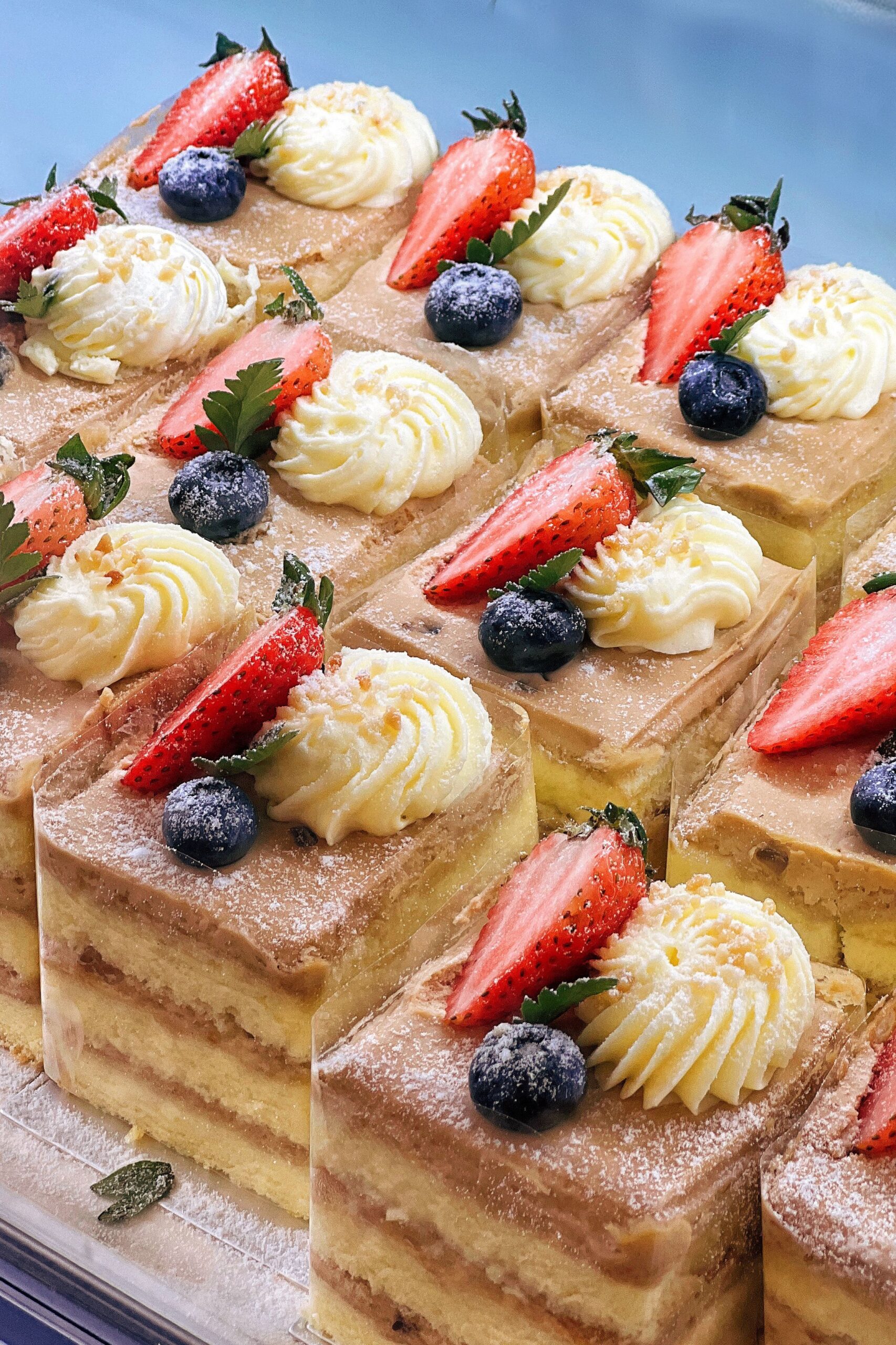 Tray of cakes with strawberries and blueberries